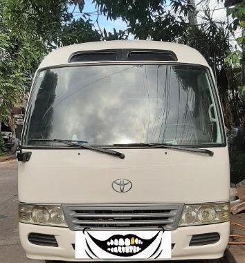 White Toyota Coaster 2008