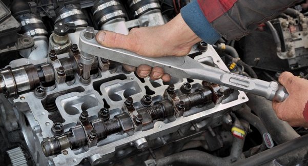 What does a car engine camshaft do?