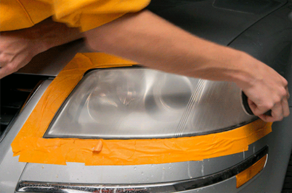 Use a piece of 2,000-grit sandpaper and lightly sand vertically. Wash the headlights
