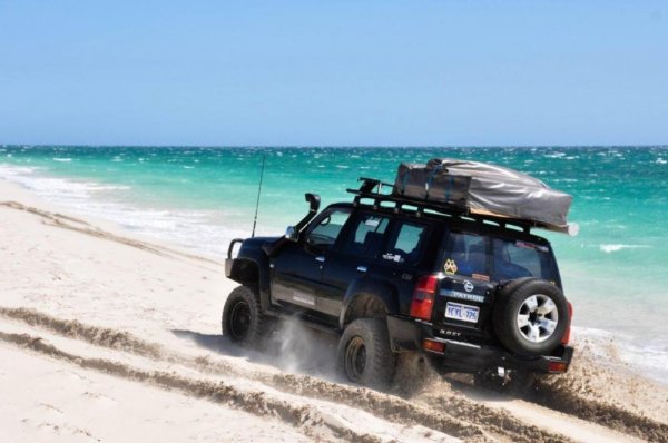 Keep your momentum up and stop only when you feel safe. SUV on the beach