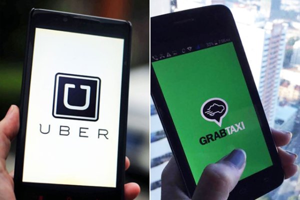 Taxi drivers’ group protests TNC operators Uber and Grab are running on two mobile phones