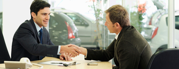 Remember to offer a number that is lower than your maximum price The car salesman shaking hands with the car buyer