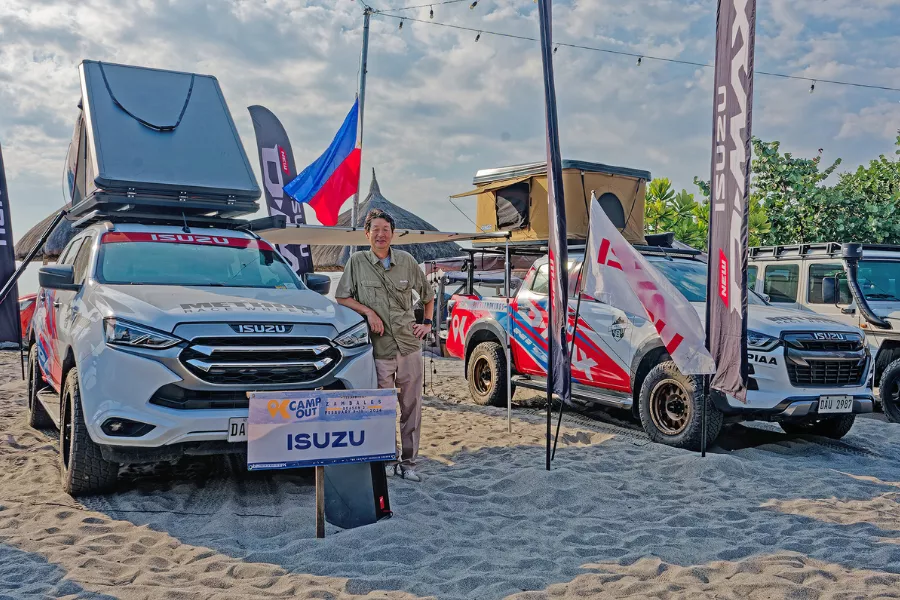 IPC President Tetsuya Fujita with the Isuzu D-Max and mu-X overland rigs.