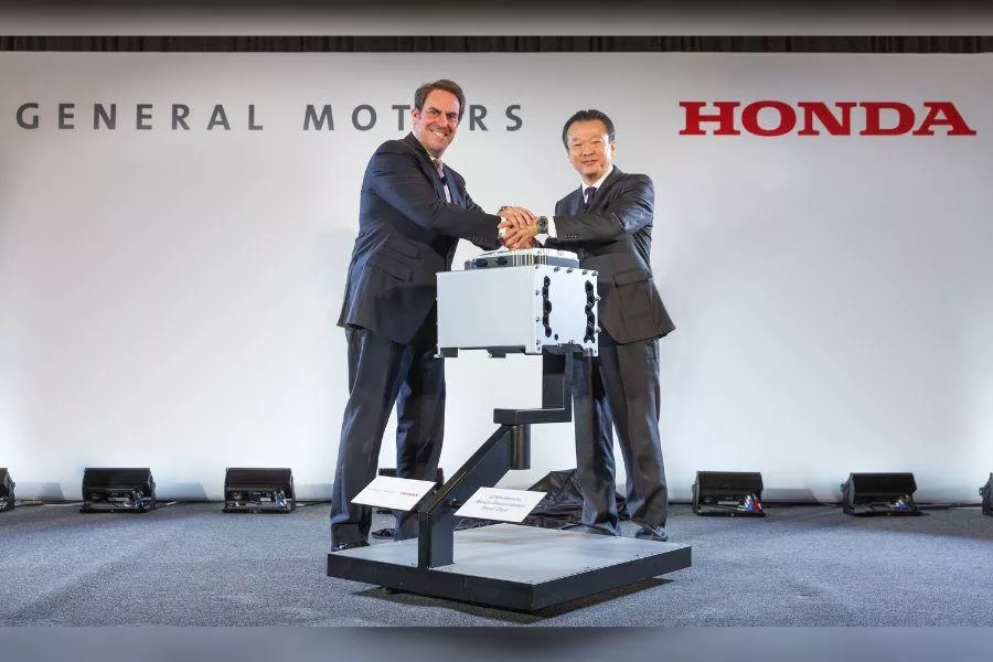 A picture of GM and Honda executives shaking hands