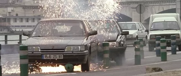 Two cars chasing and firing at each other