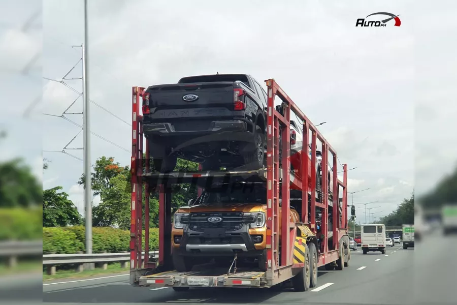 A picture of a car carrier with several 2023 Ford Ranger units.