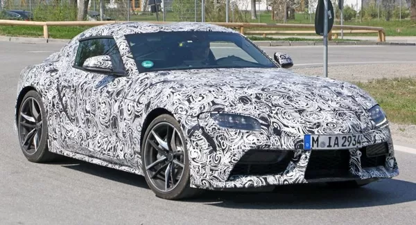 The angular front of the camoflaged Toyota Supra 2019