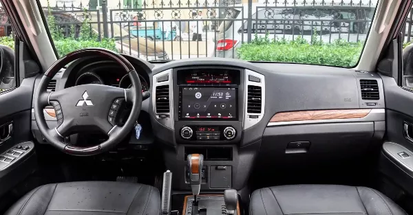 On the dash are faux wood panels and throughout the cabin are leather-wrapped 4-way adjustable seats 2019 mitsubishi pajero interior