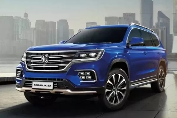 A picture of a blue MG RX-8 with a city for the background