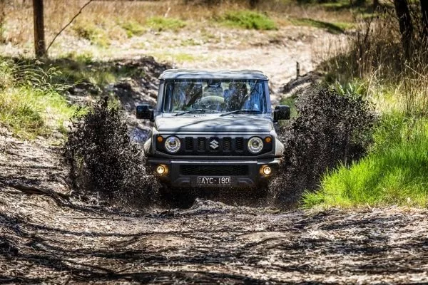 Suzuki Jimny wading through mud