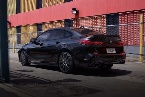 A picture of the BMW 2-Series Gran Coupe's rear end as it passes through a street in the city