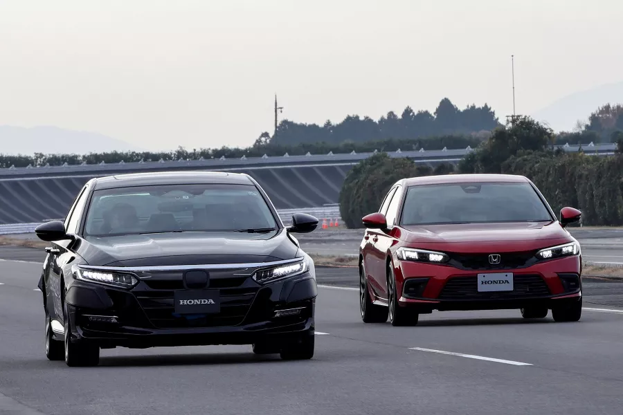 A picture of Honda vehicles on the road.