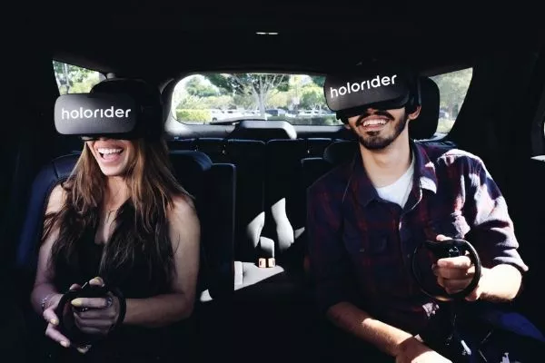 A picture of people wearing 3d headsets inside a car