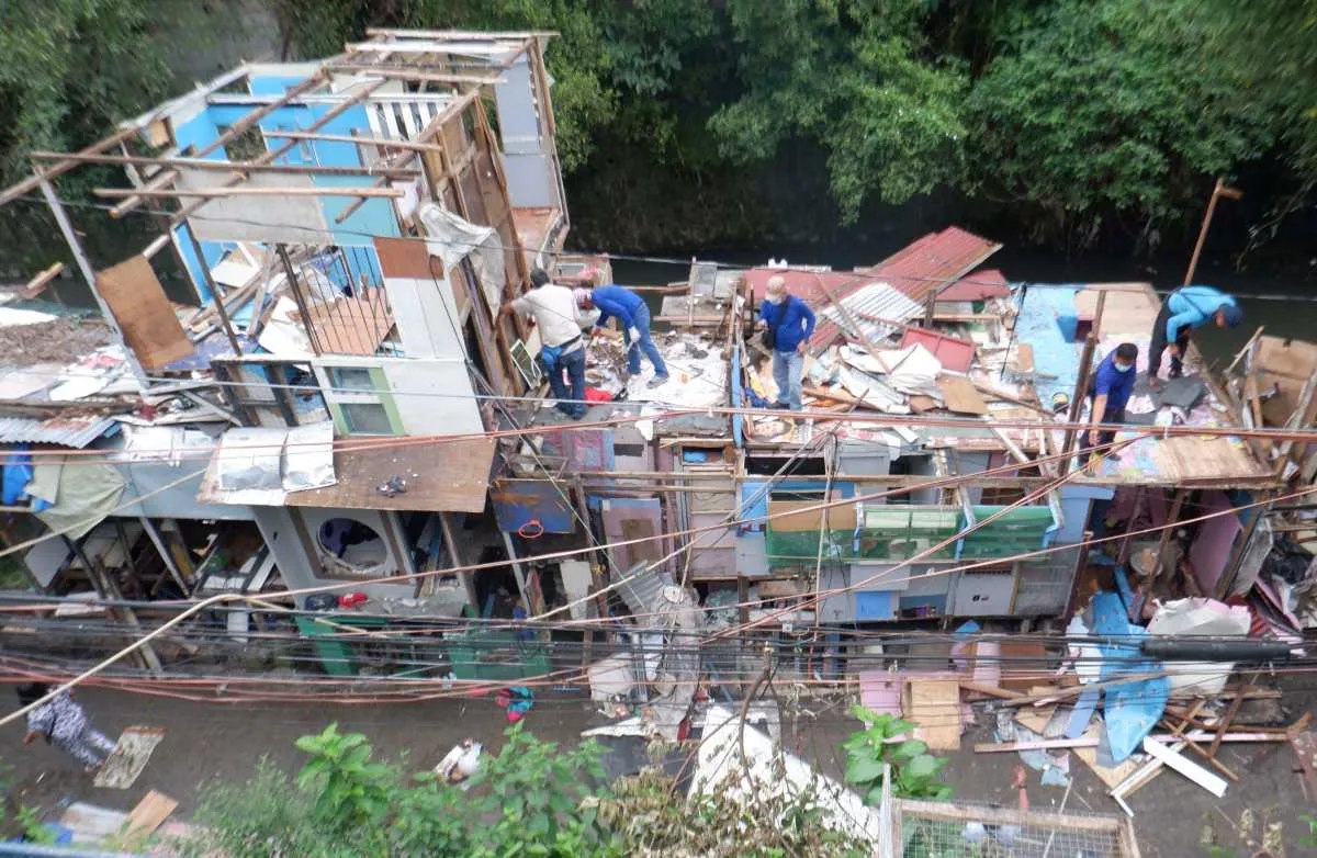 Clearing shanties along creek