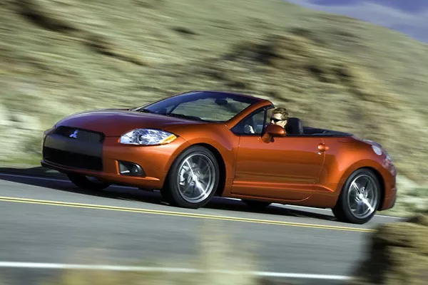 A picture of the 4th-gen Eclipse speeding on a mountain road.