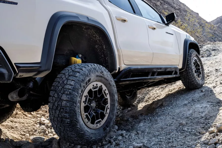 Many of its variants are ready to go off-road even in stock form A picture of a 2023 Chevy Colorado dealing with rough terrain.