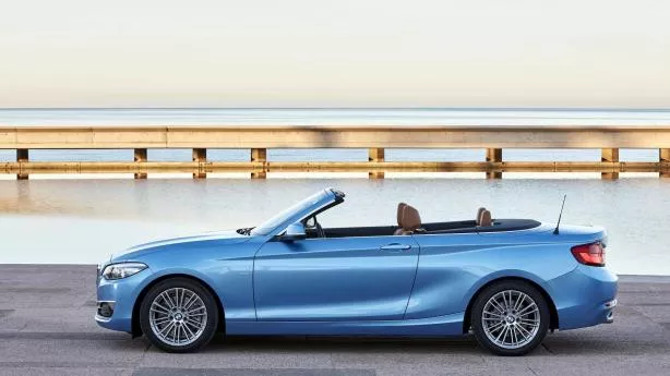 This car is decorated with four sets of alloy wheels. Side view of BMW M2