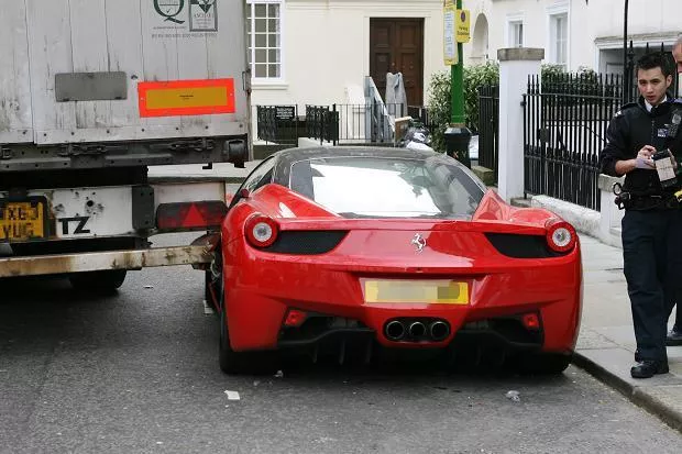 A red Ferrari California parked on the street