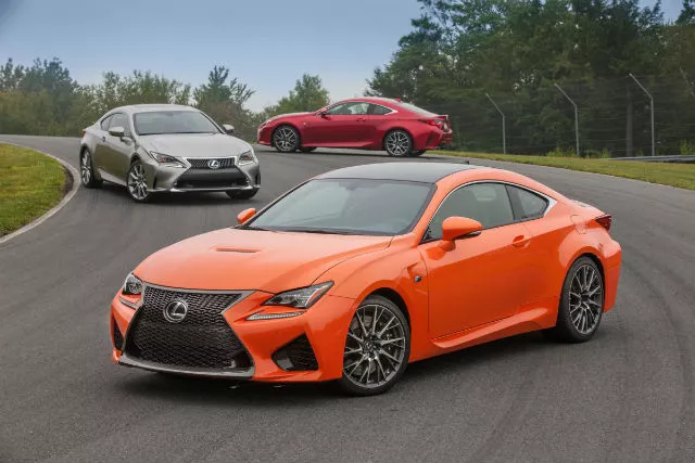 three cars of different colors on the street