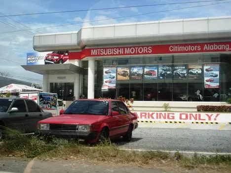 A red car parking in front of CT Citimotors