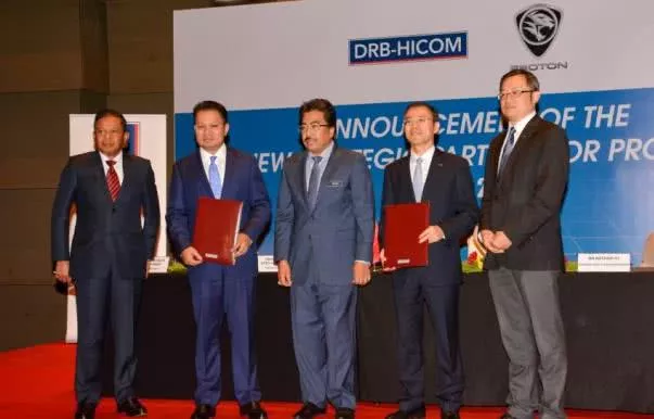 5 men in front of Proton Geely announcement backdrop