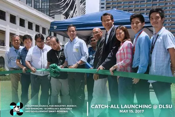 People cutting a green ribbon at the launching ceremony of CATCH-ALL