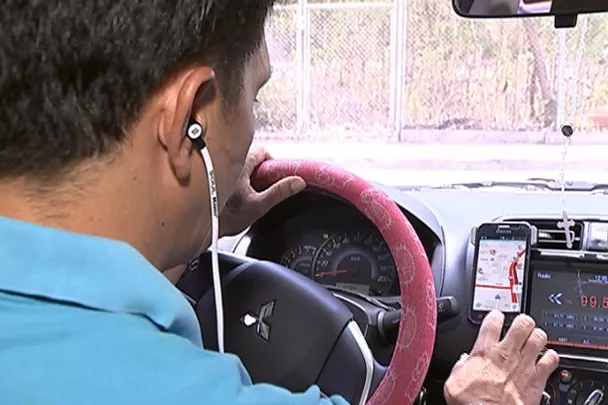 A man using in a car a smartphone to check destinations