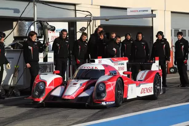 Group of people are checking a racing car