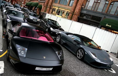 lines of black luxury cars on the street