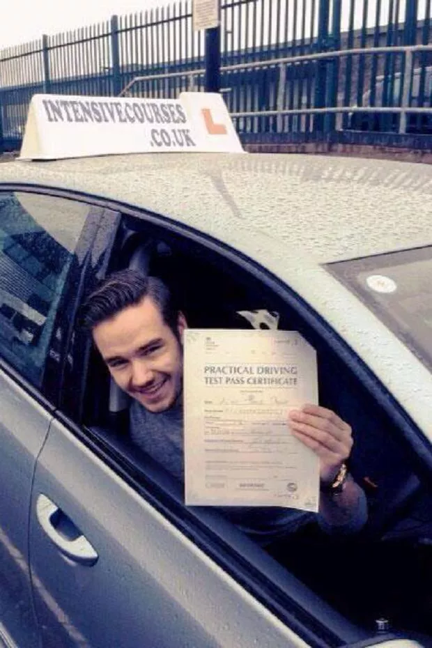 Liam Payne Liam Payne sitting in a car and holding a sheet of paper