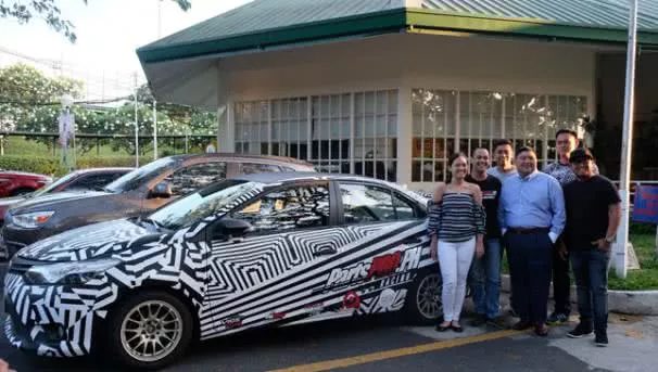 Parts Pro racing team Racing team standing beside a toyota racing car