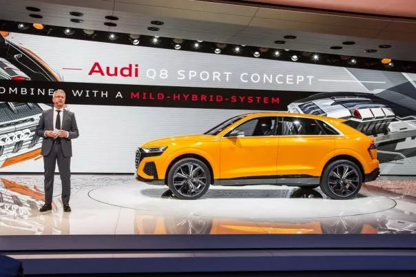 The Audi Q8 Sport Concept is considered as the preview of the RS Q8 A man standing next to the Audi Q8 Sport at 2017 Geneva Auto Show