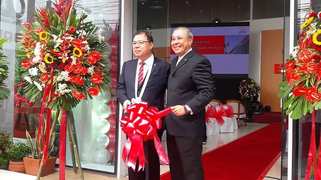 Two men cutting the ribbon