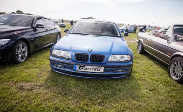 A blue BMW car on grass yard