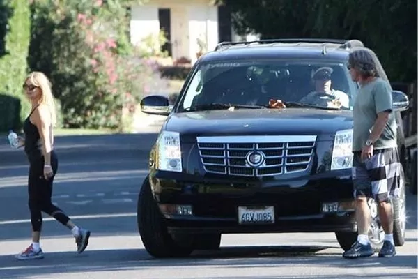 Here's the man himself, driving his Escalade Hybrid A picture of Adam Sandler driving his Escalade Hybrid