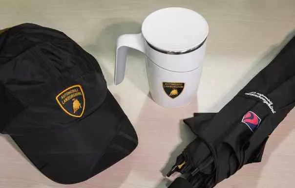 A Lamborghini umbrella, a Lamborghini anti-spill mug, and a Lamborghini cap