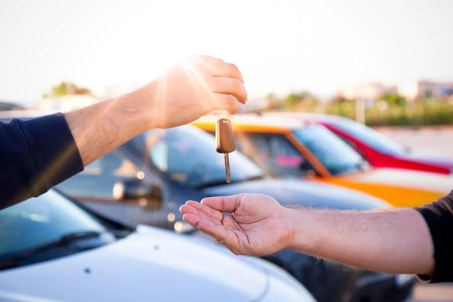 Handing over a car key in a car dealership