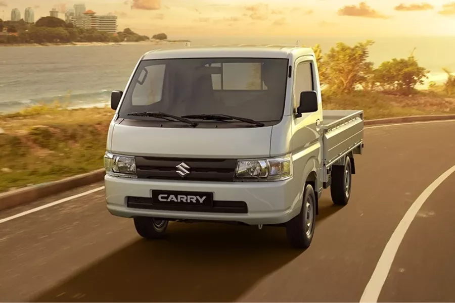 A picture of the Suzuki Carry truck variant on the road.