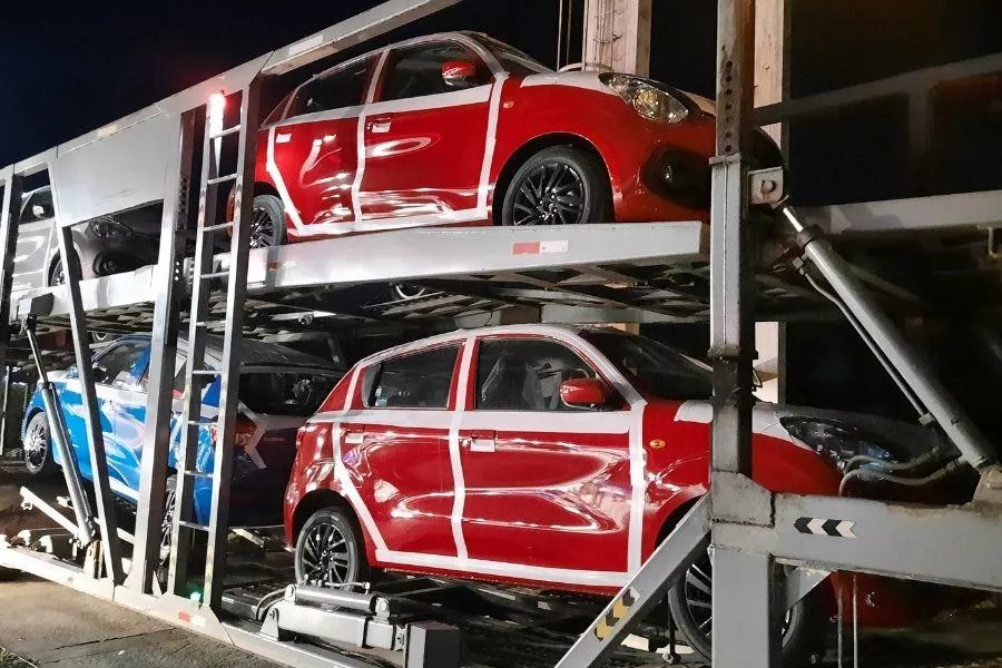 A picture of 2022 Suzuki Celerios loaded on a car carrier truck