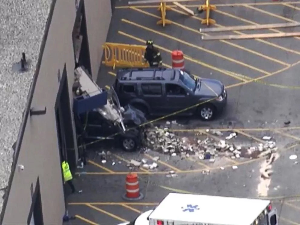 two cars crashing through a wall