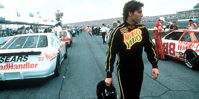 Tom Cruise  in a black racing suit