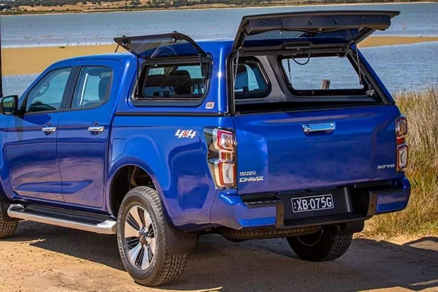 The 2021 D-Max equipped with an ARB Canopy A picture of the 2021 D-Max with ARB Canopy parked near a lake
