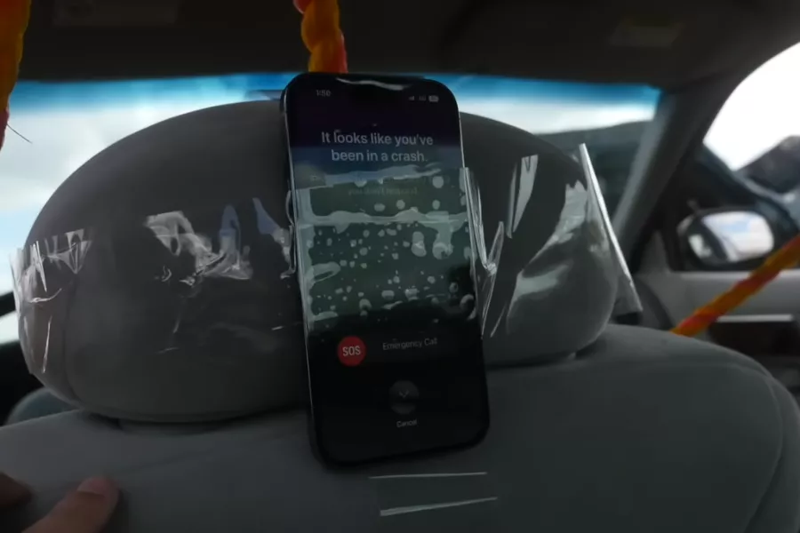 A  picture of an Iphone 14 Pro taped to the back of a headrest