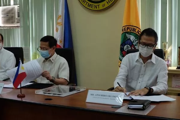 DOH secretary and TMP president signing an agreement