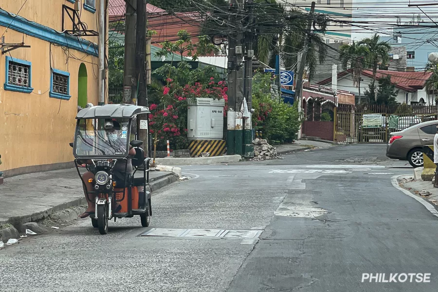 A picture of an e-trike on a two-lane road