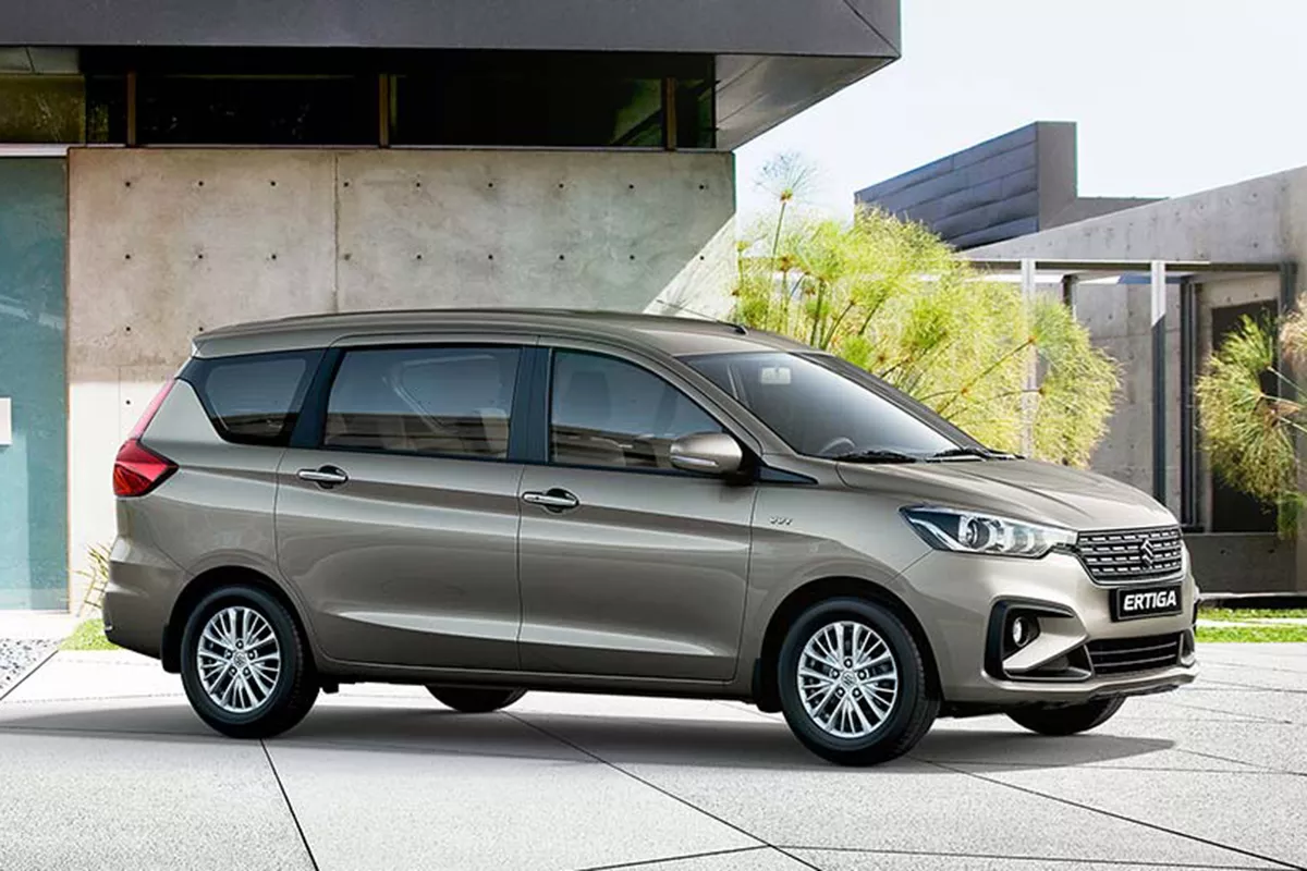 A picture of an Ertiga parked near a modern house