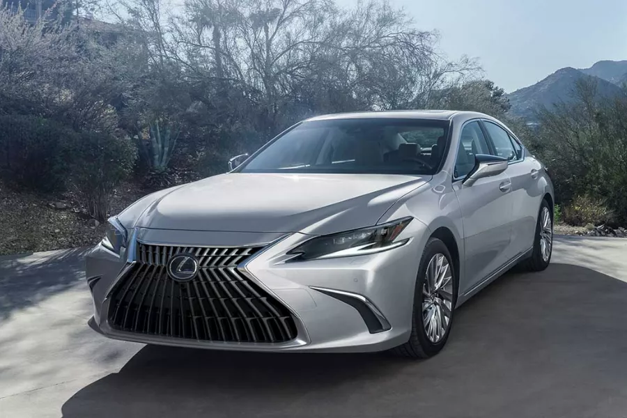 A picture of the Lexus ES 300h hybrid parked near a house.