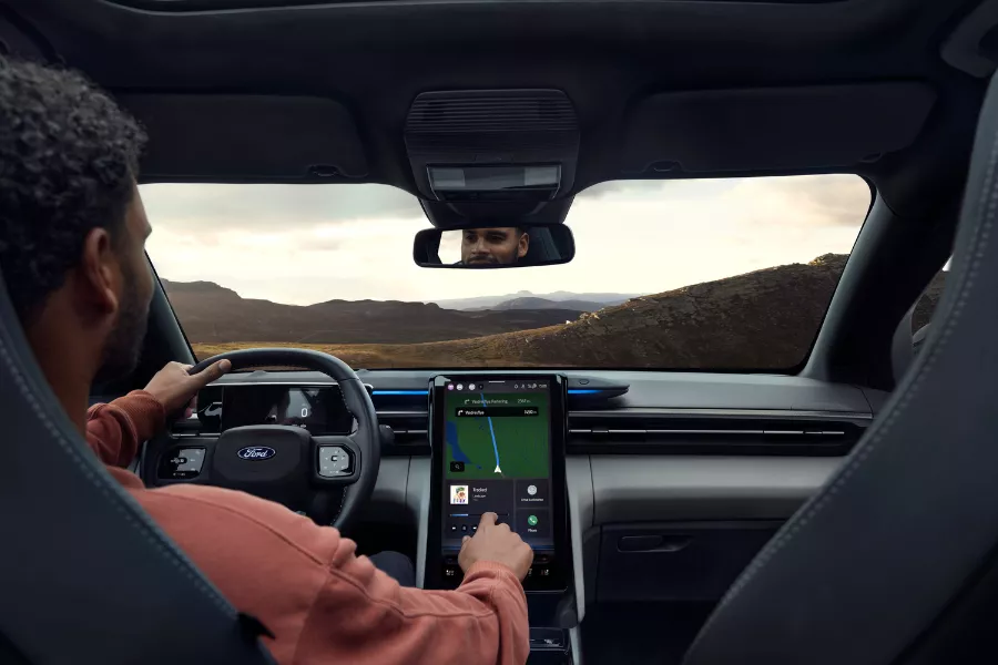 A picture of a person using the Explorer EV's touchscreen
