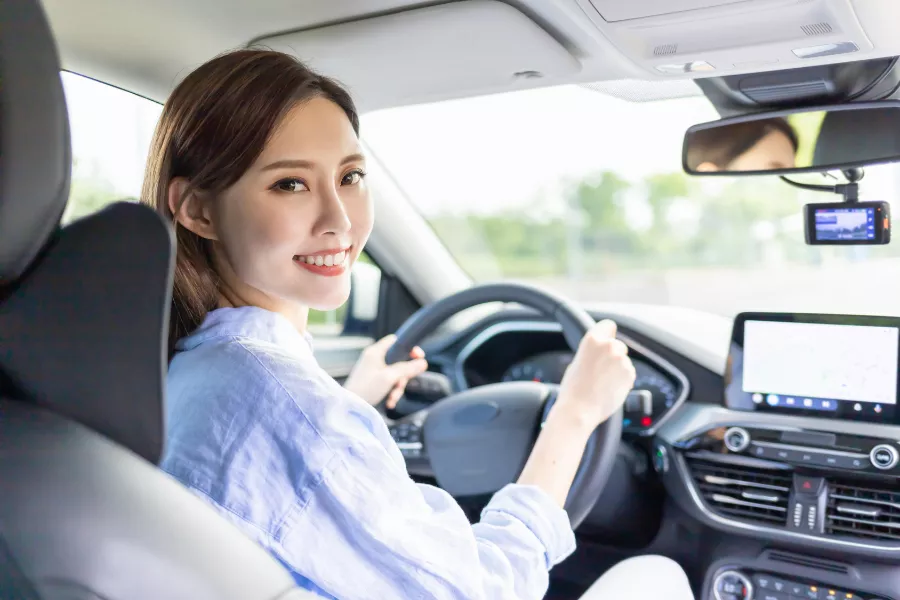 A picture of a woman behind the wheel.