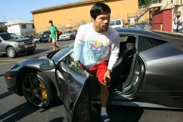 A picture of Pacquiao getting out of his favorite car; the Ferrari 458 italia